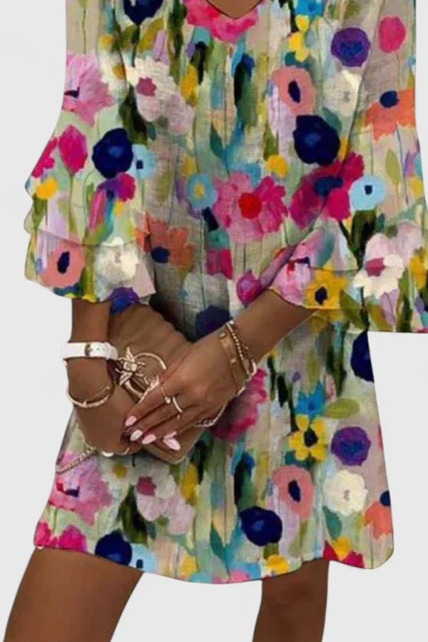 Close-up detail of the fabric and floral print on the summer mini dress, highlighting the quality and colour saturation.