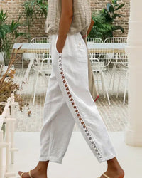 Close-up of the breathable linen fabric and elegant hollow-out design on the side of the trousers.