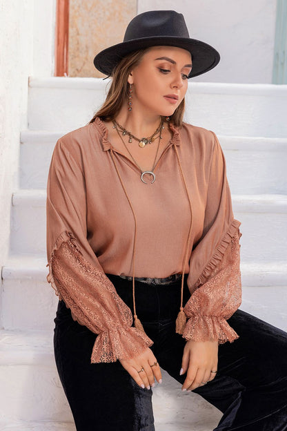 Front view of the dusty pink Solana plus size tie neck blouse, showcasing its elegant ruffled details.