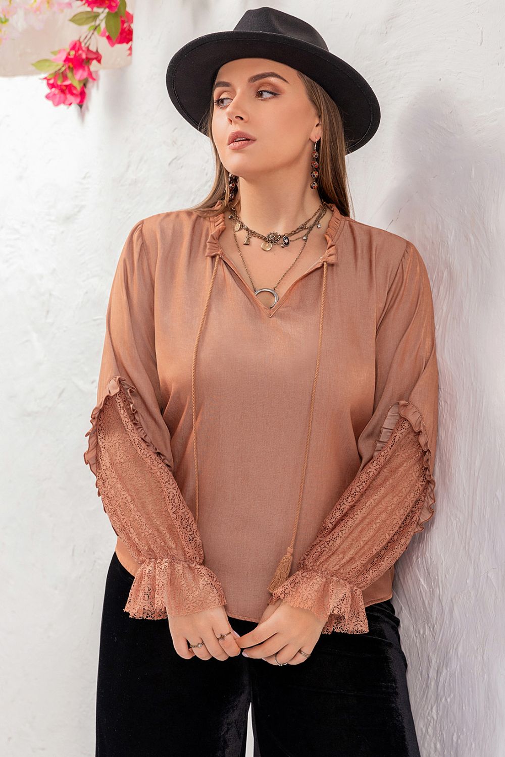 Side profile of a model wearing the dusty pink Solana plus size blouse, demonstrating the comfortable fit.