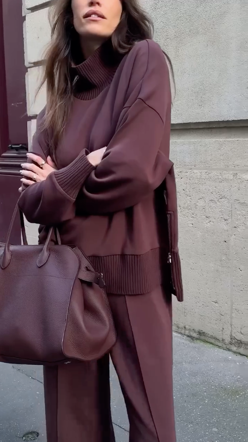 Side profile of a model wearing the Solstice cream matching top and wide leg trousers, highlighting the flowing silhouette.
