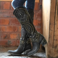 Close-up detail of the studded Western accents on the shaft of a white Rhiannon knee-high western boot.