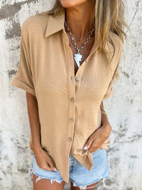 Close-up of the fabric drape on a white Seraphina classic collared shirt when worn.