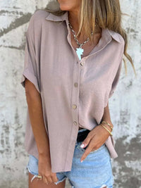 Back view of a tan Seraphina classic collared shirt, illustrating the smooth silhouette and hemline.