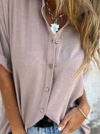 Detail shot of the buttons on a white Seraphina classic collared shirt, displaying the quality fastenings.