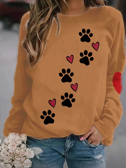 Close-up detail of the paw print motif on the fabric of the women's printed jumper, showcasing texture.