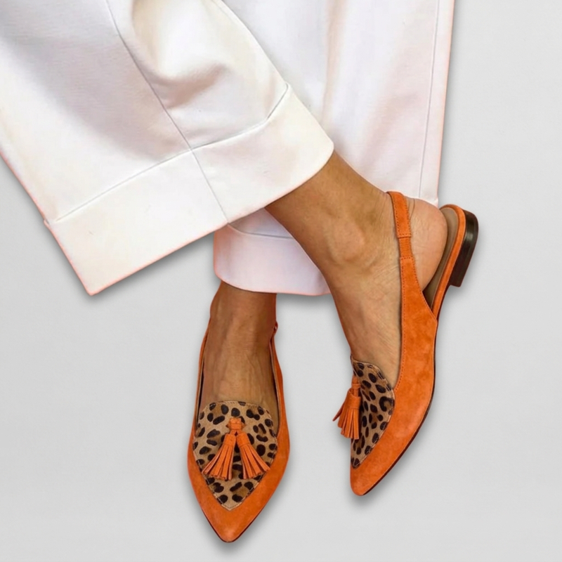 Front view of Verity artisan flat sandals in orange and leopard print, showcasing the intricate straps.
