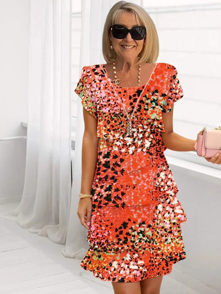 Front view of an orange-red elegant ruffle midi dress, showcasing its flowing A-line silhouette and delicate layered ruffles.