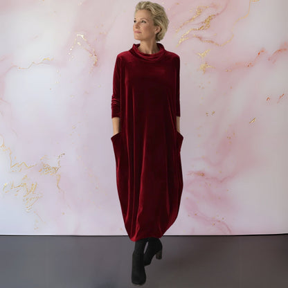 Close-up detail of the modern stand-up collar on the shimmering velvet maxi dress, highlighting its texture.