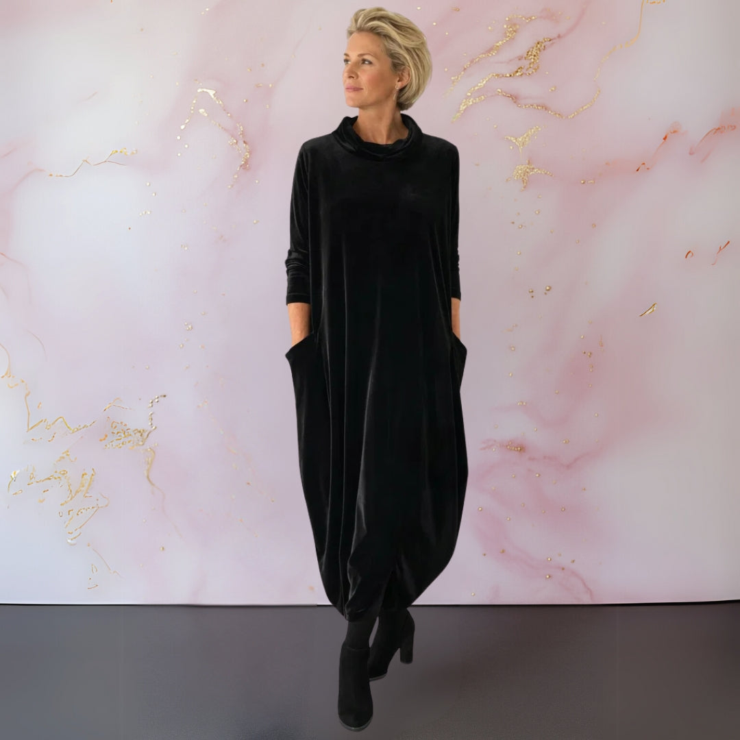Back view of the sophisticated black velvet maxi dress, emphasising its full length and comfortable fit.