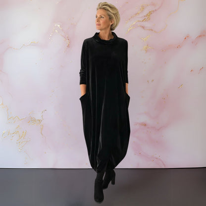 Back view of the sophisticated black velvet maxi dress, emphasising its full length and comfortable fit.