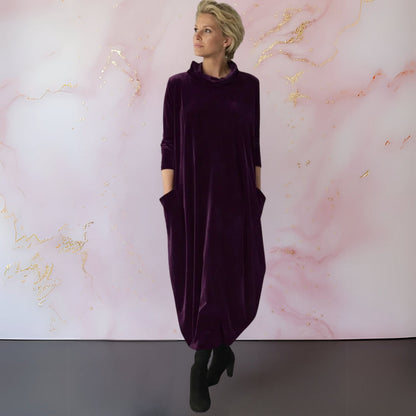 Lifestyle shot of the purple Yara velvet maxi dress, perfect for an evening event, showing its elegant drape.