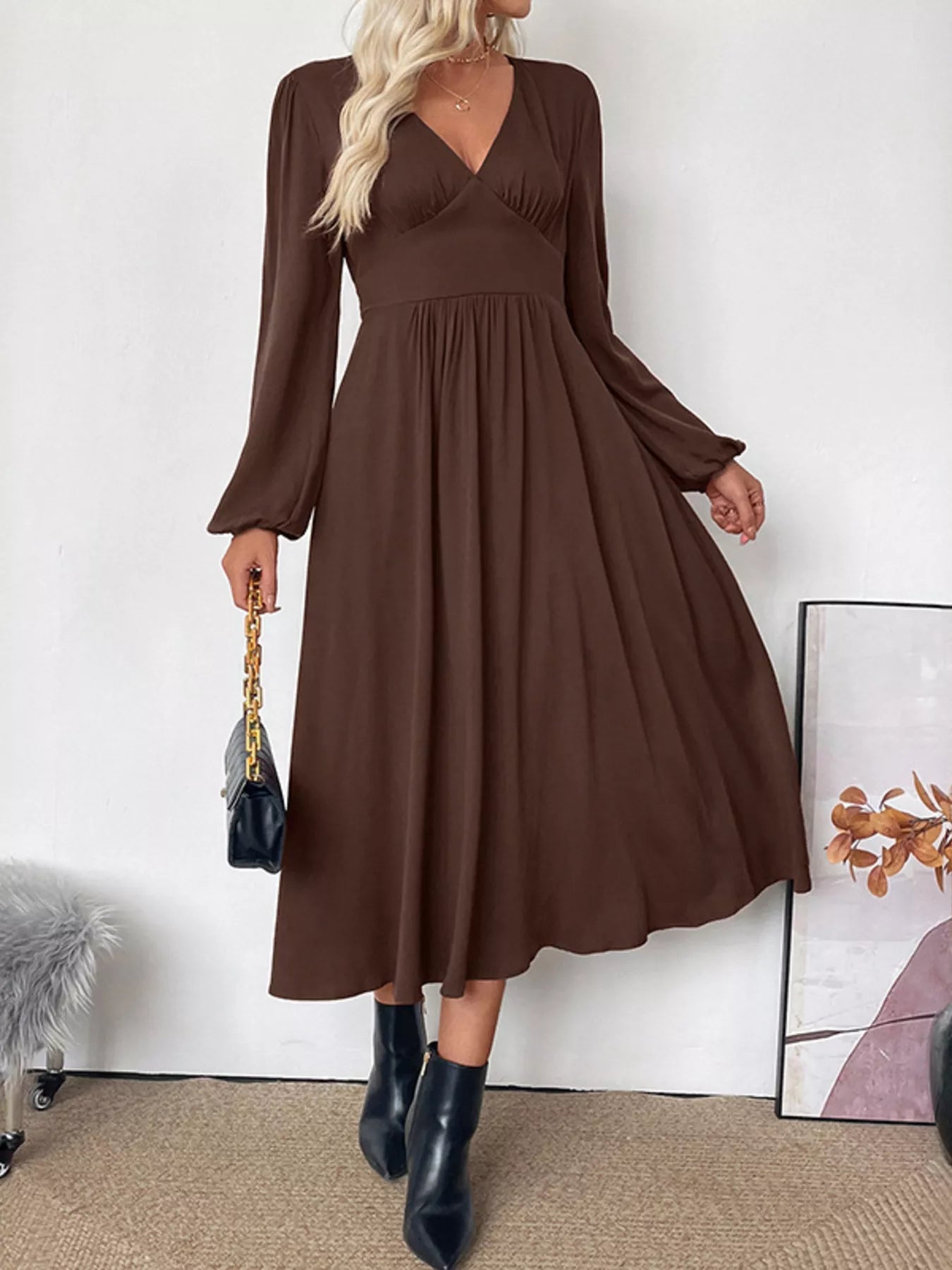 Side profile of the elegant brown Zara A-line midi dress, highlighting its flowing silhouette.