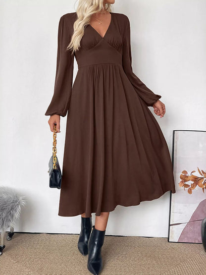 Side profile of the elegant brown Zara A-line midi dress, highlighting its flowing silhouette.