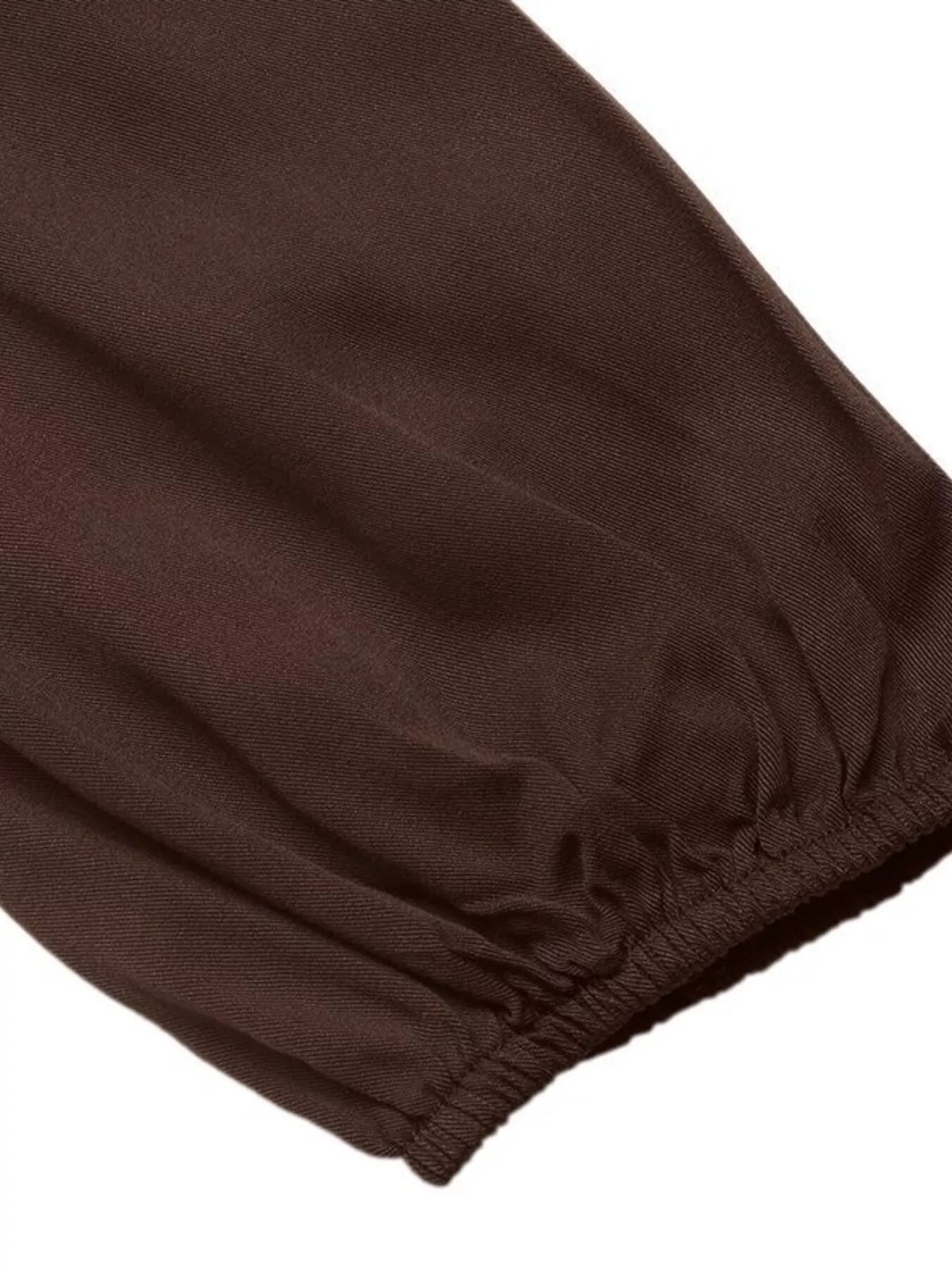 Lifestyle image of the brown viscose midi dress, styled for a relaxed outdoor autumn look.
