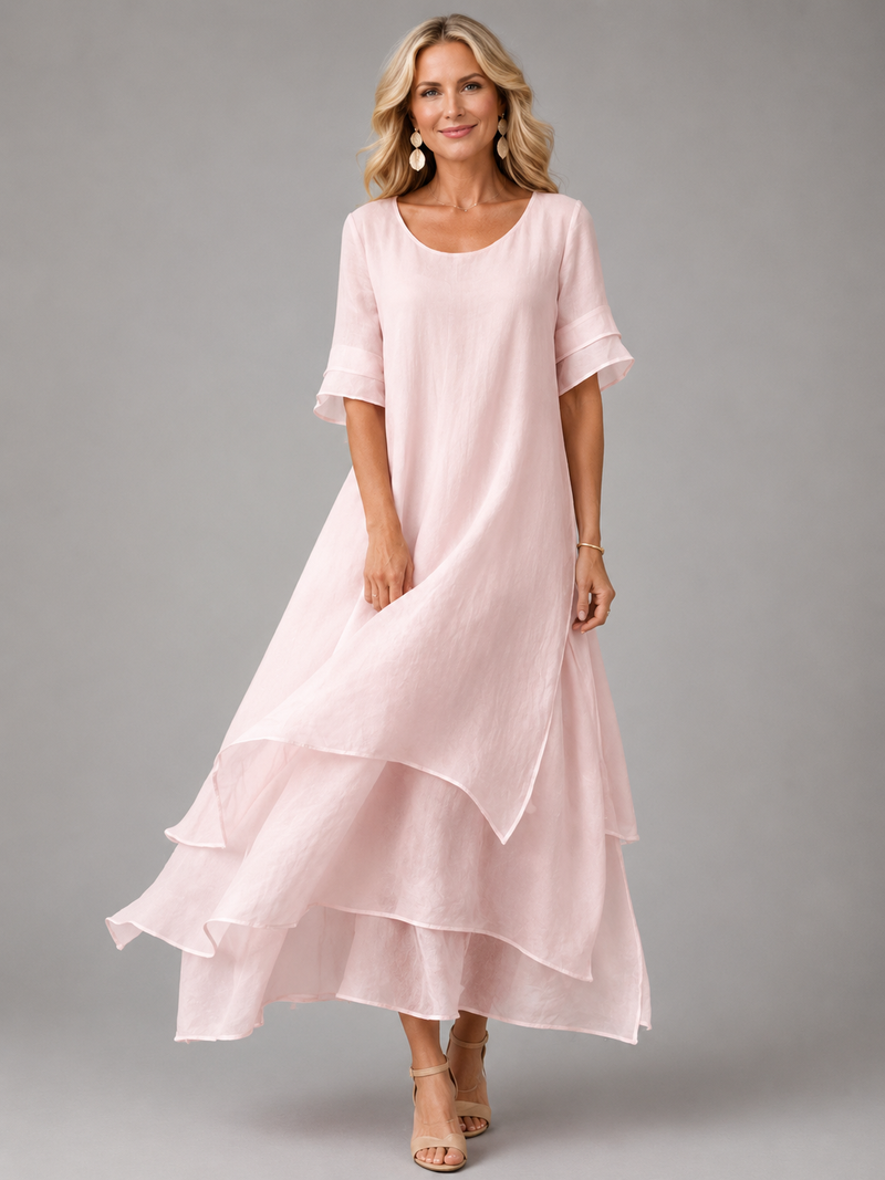 Front view of a woman wearing the Zelda Graceful Tiered Maxi Dress in a vibrant pink, showcasing its relaxed fit.