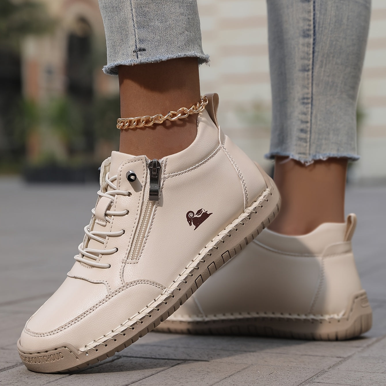 A pair of Elara everyday supportive shoes in a soft pink shade, shown from a slightly elevated front-side angle on a neutral background, highlighting their cushioned design and wide toe box.
